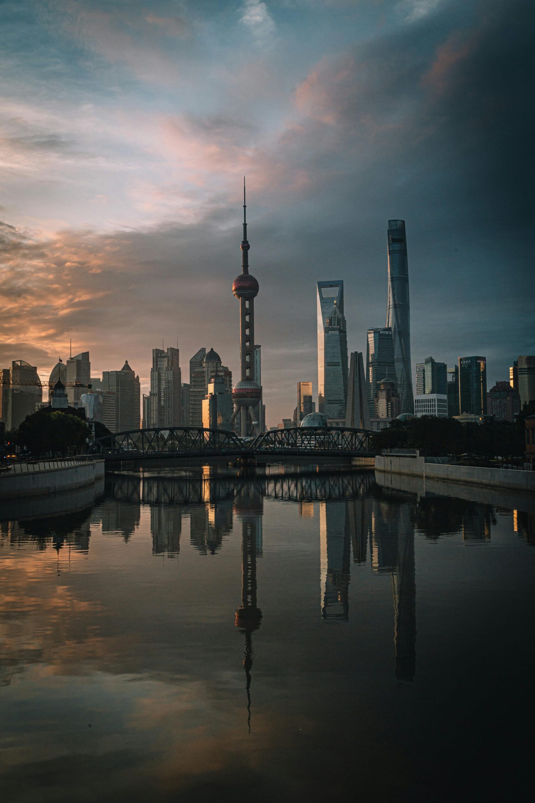 Stunning sunrise view of Shanghai's skyline reflecting on the river, highlighting iconic landmarks.